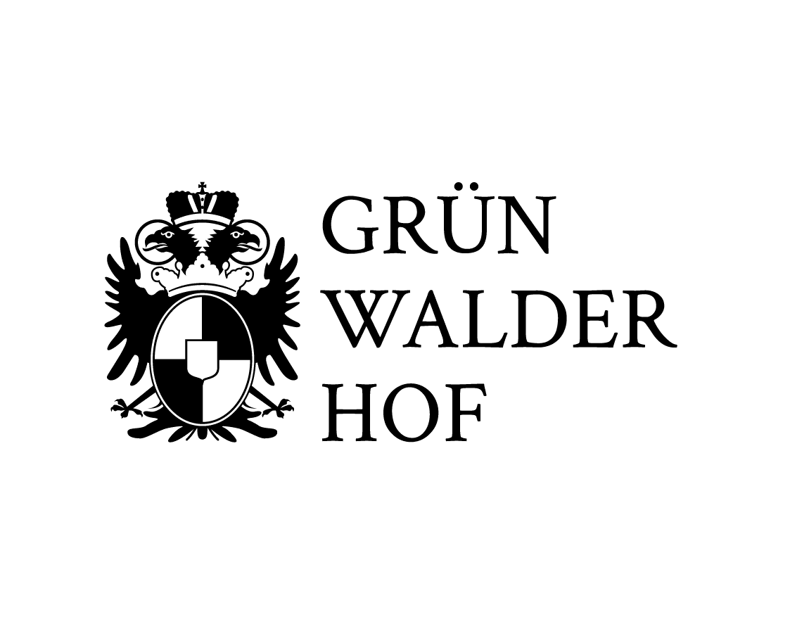 Schwarzes Adlerwappen mit Schild neben dem Text GRÜN WALDER HOF auf weißem Grund.